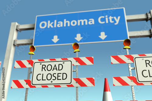 Road barricades near Oklahoma City road sign. Coronavirus disease quarantine or lockdown in the United States conceptual 3D rendering © Alexey Novikov
