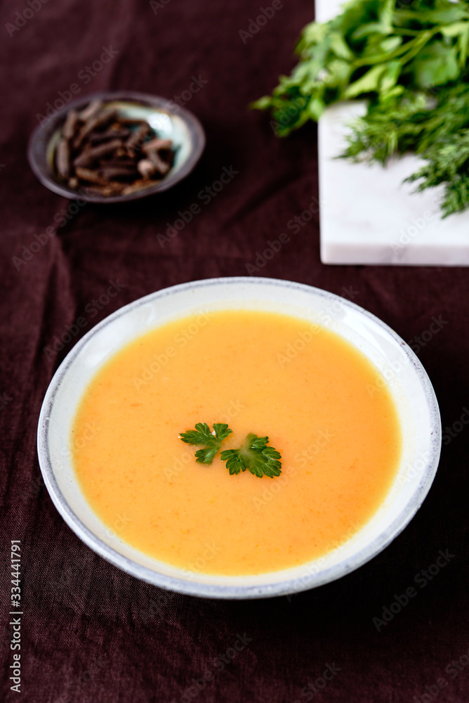 Healthy Vegetable Cream Soup in a bowl on linen tablecloth. Vertical composition. Selective focus Healthy Vegetable Cream Soup in a bowl on linen tablecloth. Vertical composition. Selective focus