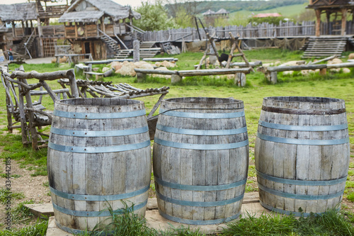 Ancient wooden barrels surrounded by a reconstructed medieval village.