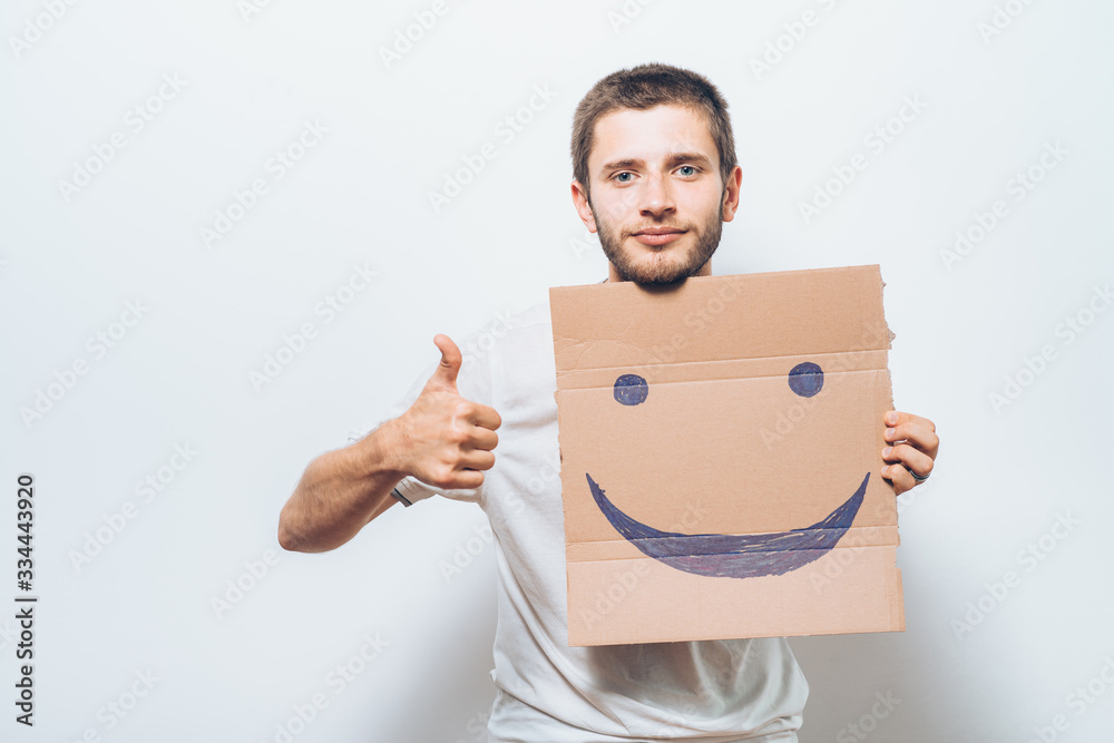 man, holding a picture with a cheerful smiley man, holding a picture with a cheerful smiley