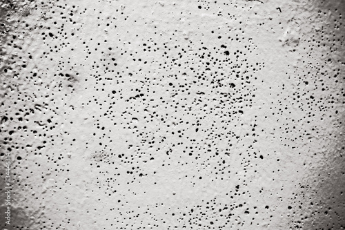 gray cement background with pores and holes
