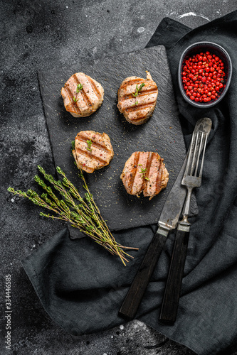 Tender boneless grilled pork chops. steak tenderloin. black background. Top view