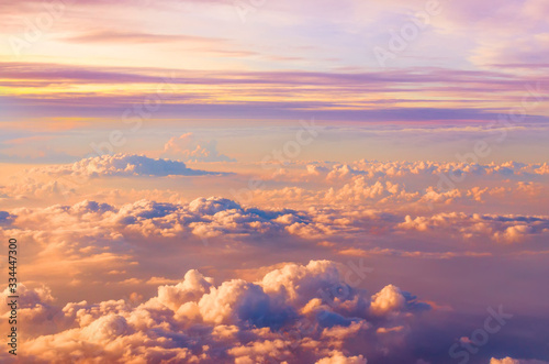 Beautiful saturated sunset sky panoramic view above clouds with dramatic light.