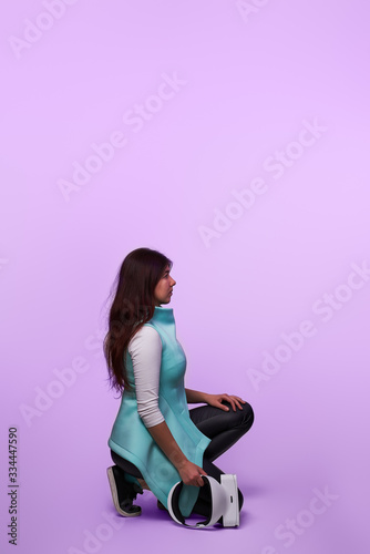 Woman with virtual reality headset in her hands.