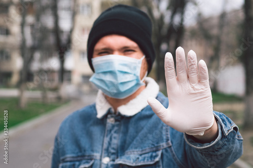 A man in a viral mask and in protective gloves, protection in prevention for coronavirus. 