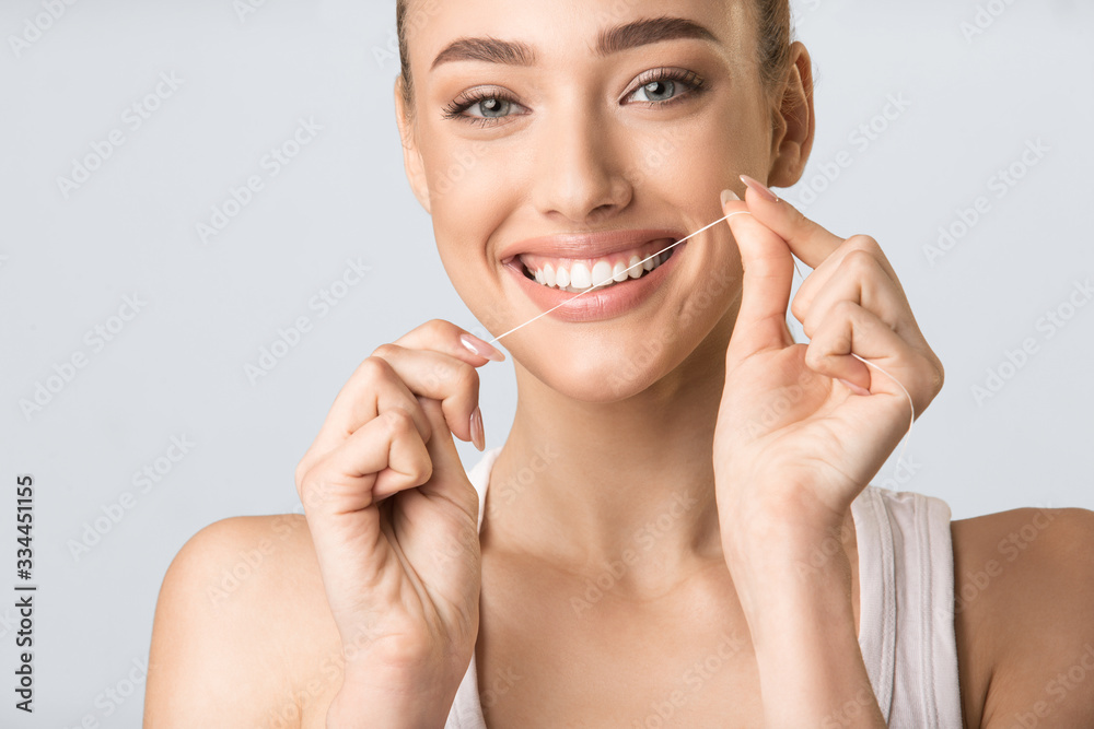 Girl Flossing And Cleaning White Teeth Posing In Studio, Cropped Girl Flossing And Cleaning White Teeth Posing In Studio, Cropped