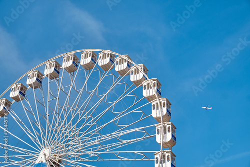 Ferris wheel and a plane. Lisbon, Portugal. photo