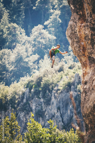 Man climbs a rock. 