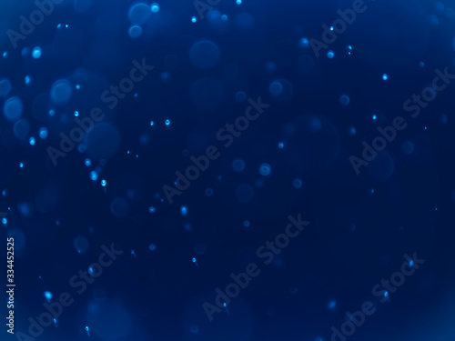 White bokeh on a blue background .Blue bokeh background. Blur background. White bubbles.