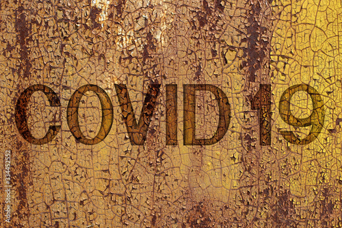 Inscription Covid on a rusty metal wall. Background on theme of coronavirus