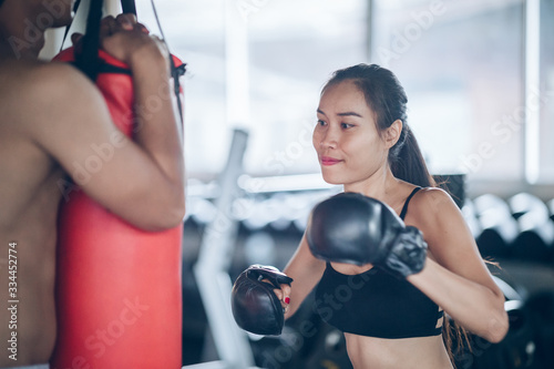 young women boxer punching bag at training fitness gym © iStocker
