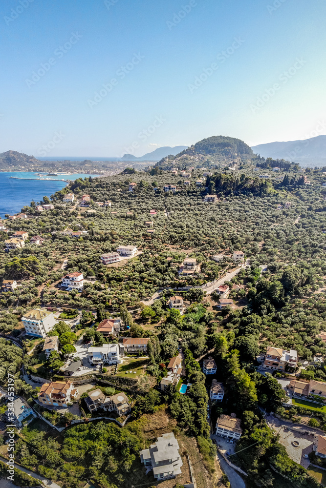 Incredible view towards the Zakynthos town and Bochali viewpoint with houses and olive groves in the foreground