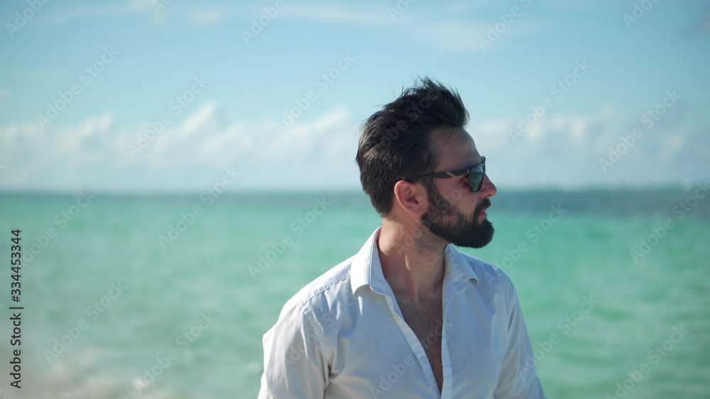 Businessman Walking On Tropical Beach.Man In White Shirt Walks Along Beach On Tropical Caribbean Hotel.Lonely Handsome Beautiful Tanned Businesman Relaxing On Maldives.Travel Mood Azure Coast Resort. Businessman Walking On Tropical Beach.Man In White Shirt Walks Along Beach On Tropical Caribbean Hotel.Lonely Handsome Beautiful Tanned Businesman Relaxing On Maldives.Travel Mood Azure Coast Resort.