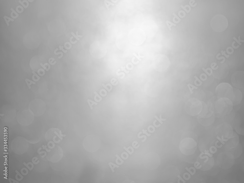 White and gray bokeh background.Abstract blur background. White bubbles on a black background.