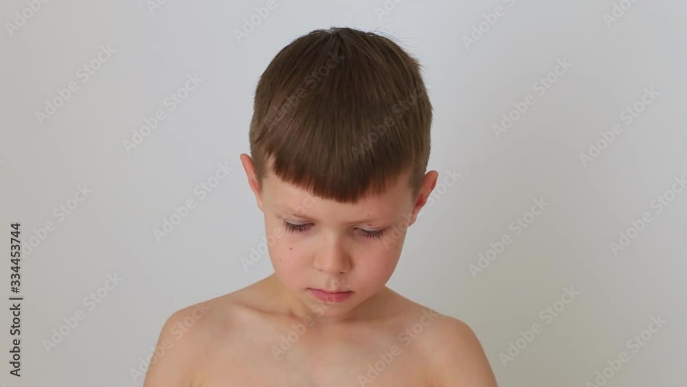 Boy puts on a quarantine respiratory mask at home Boy puts on a quarantine respiratory mask at home