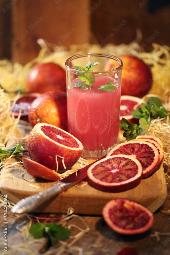 Still life with red oranges and lemons on a wooden background Still life with red oranges and lemons on a wooden background