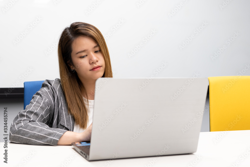 Woman working by laptop in office with happy Woman working by laptop in office with happy