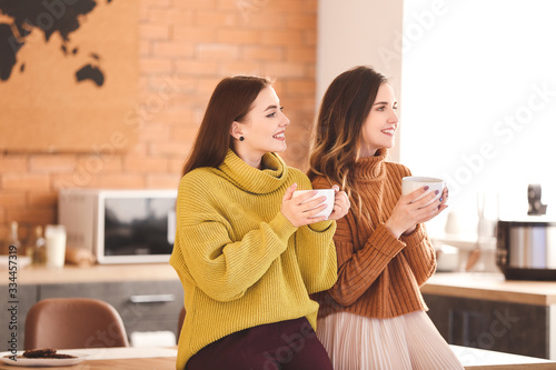 Young women drinking tea in...