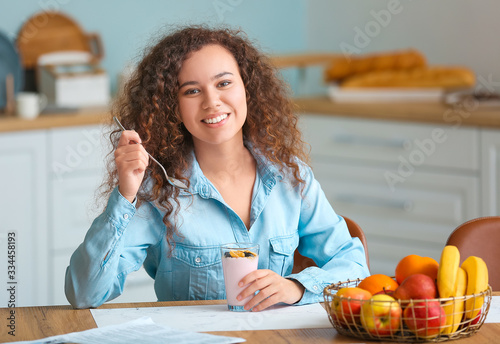 Young woman eating tasty yo...