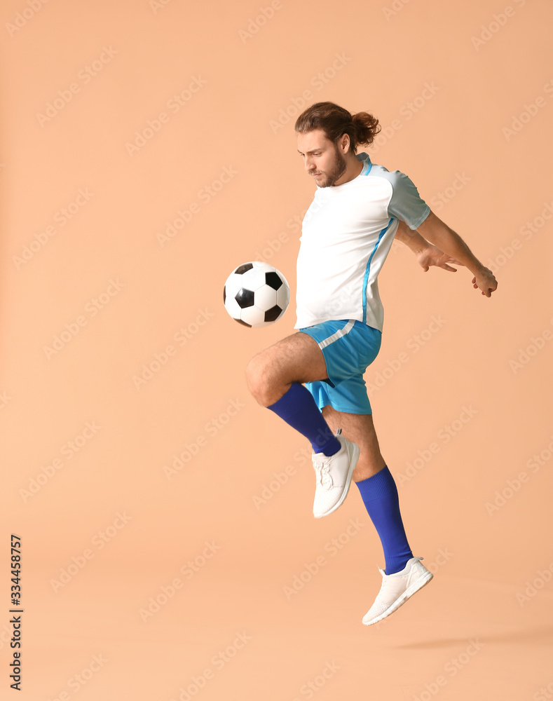 Male football player on color background