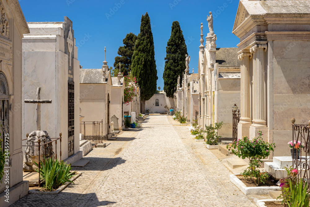 Alley on the cemetery during sunny day in Albufeira, Algarve, Portugal