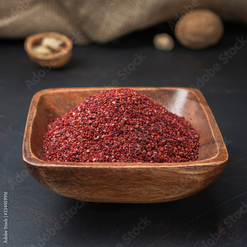 Fototapeta Naklejka Na Ścianę i Meble -  spices seasonings and grains on a square wooden bowl on a dark background and burlap