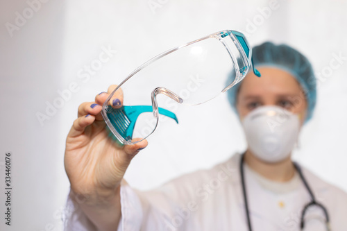  nurse or doctor with her protective equipment on showing her protective glasses