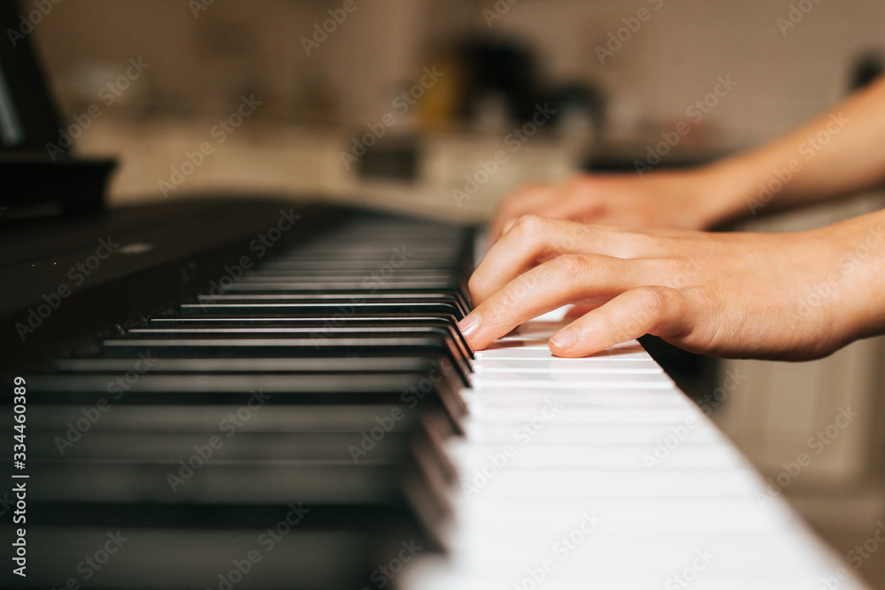 Child hands playing piano