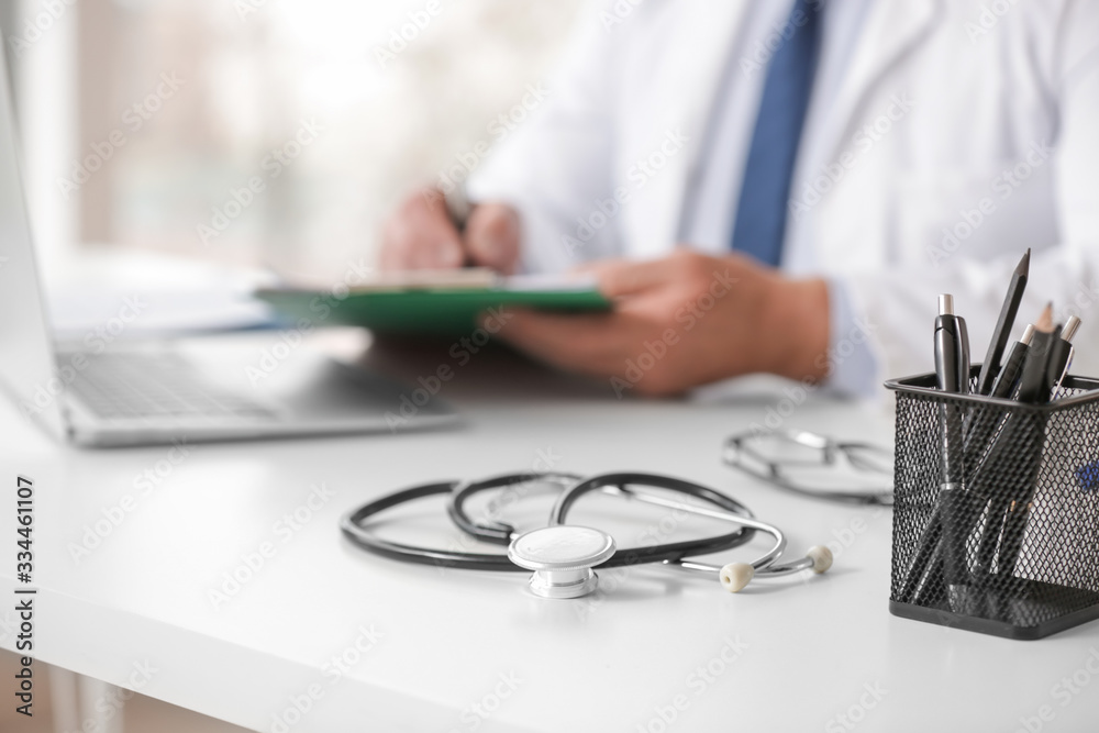 Male doctor working at table in clinic, closeup Male doctor working at table in clinic, closeup