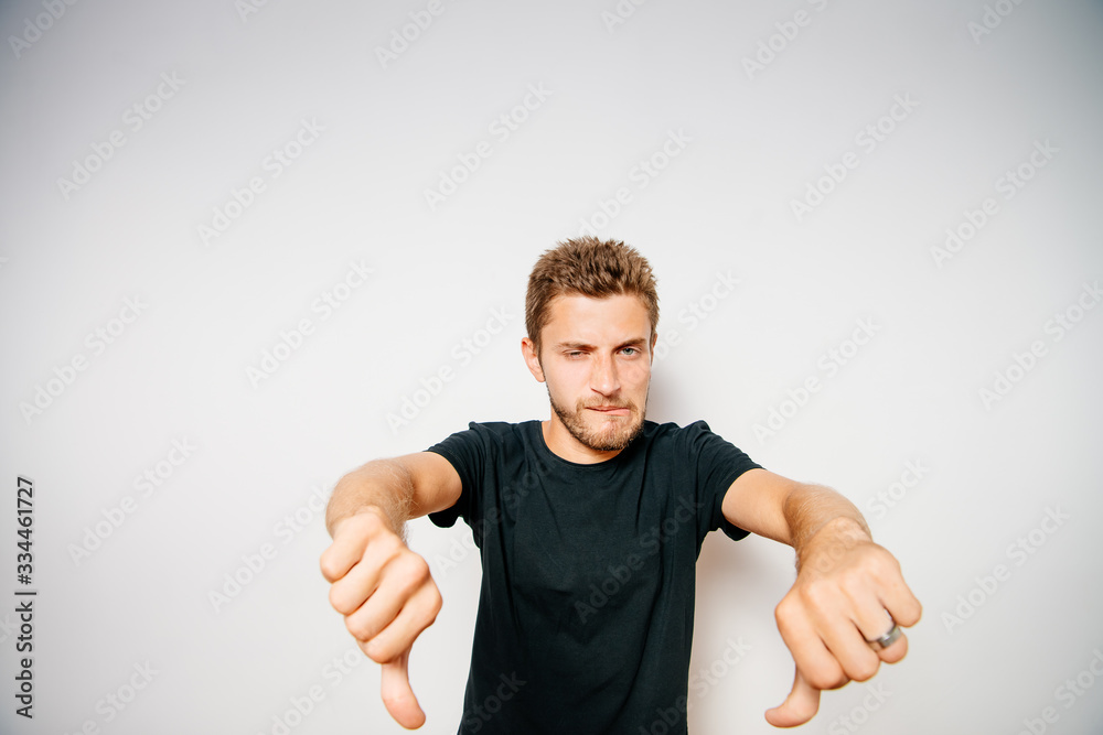 man showing a thumb down gesture man showing a thumb down gesture