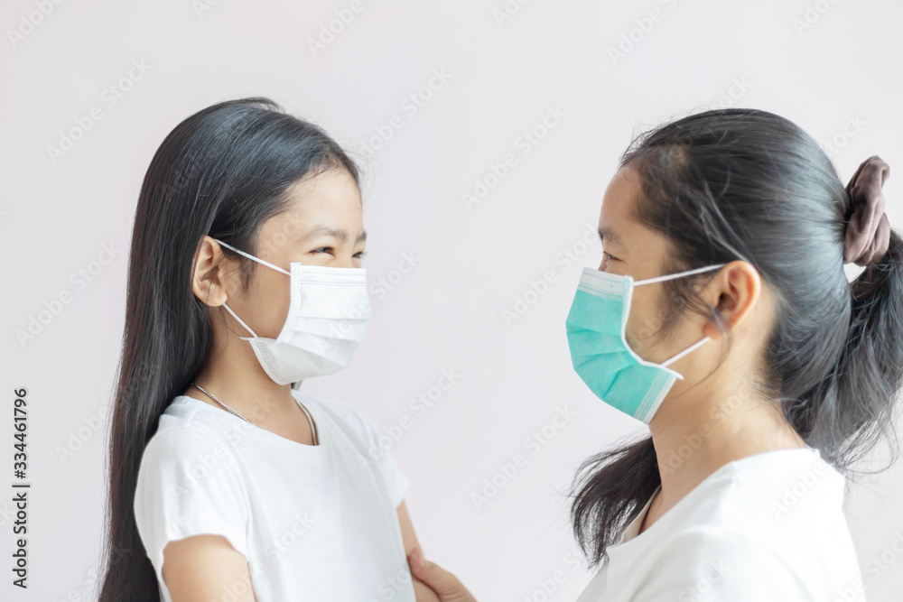 The mother and daughter wear a protective medical mask. The mother and daughter wear a protective medical mask.