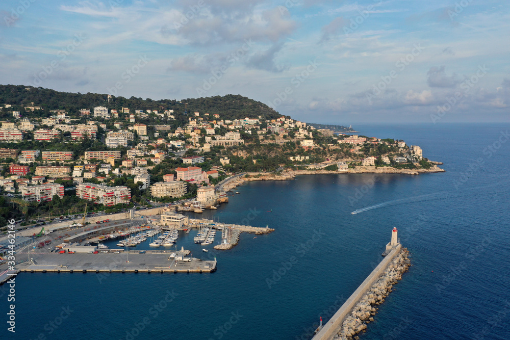 Port of nice, France, shooting from the air. Cote d'azur, the blue sea water. Rocky beach. The Harbor lighthouse.