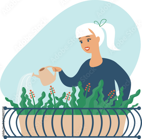 Young woman watering flowers on her city balcony garden
