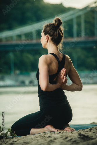 girl doing yoga by the river