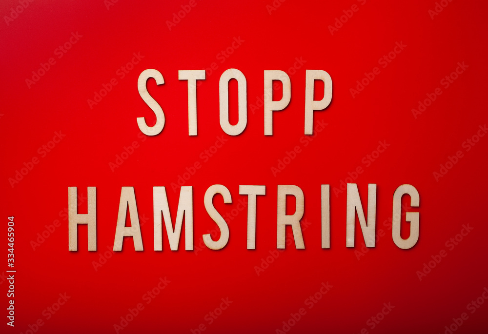 stopp hamstring norwegian word text wooden letter on red background coronavirus covid-19