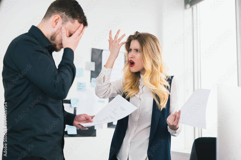 young woman general manager angry with man manager for unproper documents preparation before important deal in her modern bright office, , multitasking, subordinate employee conflict concept young woman general manager angry with man manager for unproper documents preparation before important deal in her modern bright office, , multitasking, subordinate employee conflict concept