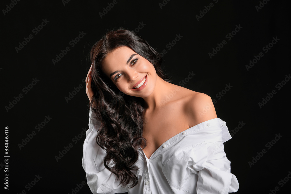 Young woman with beautiful healthy hair on dark background Young woman with beautiful healthy hair on dark background