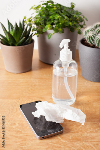 disinfecting smartphone screen, eliminating germs coronavirus bacteria photo