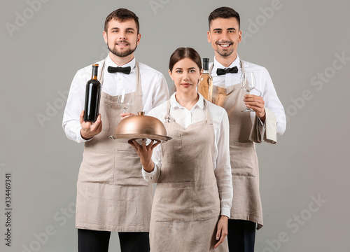 Portrait of waiters on grey...