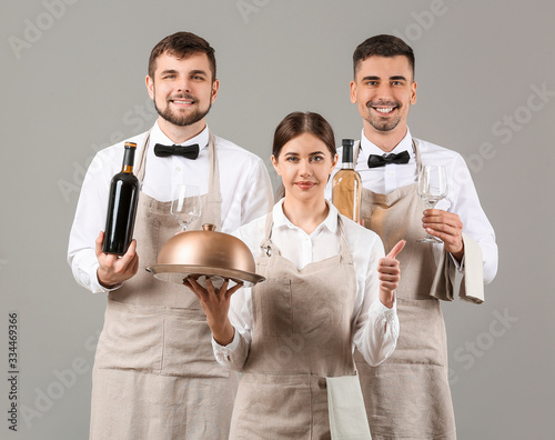 Portrait of waiters on grey...