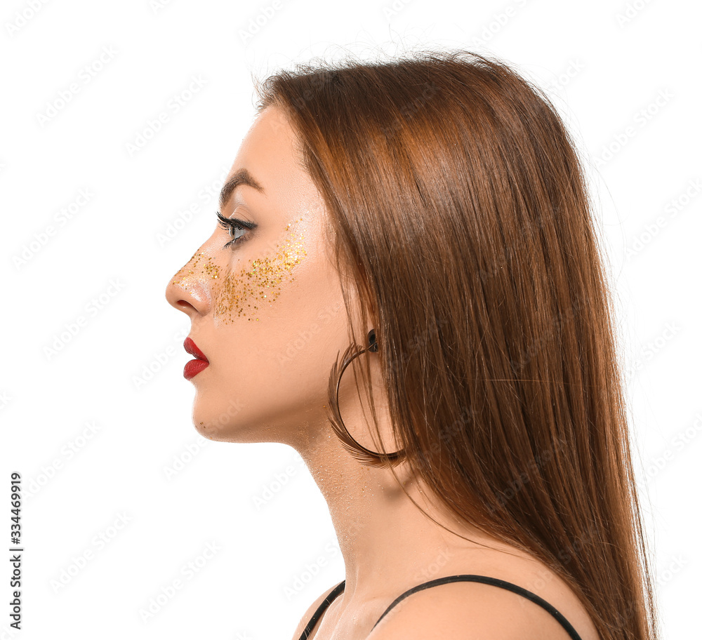 Naklejka premium Fashionable young woman with glitters on her body against white background