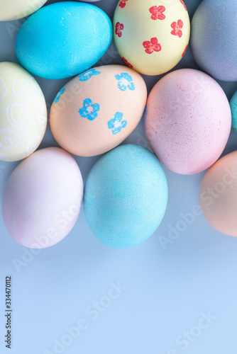Colorful Easter hunting eggs dyed by colored water with beautiful pattern on pastel blue background  design concept of holiday  top view  copy space.