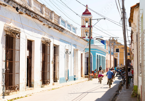 Photography Bikes in a street in Cuba with the church in the background