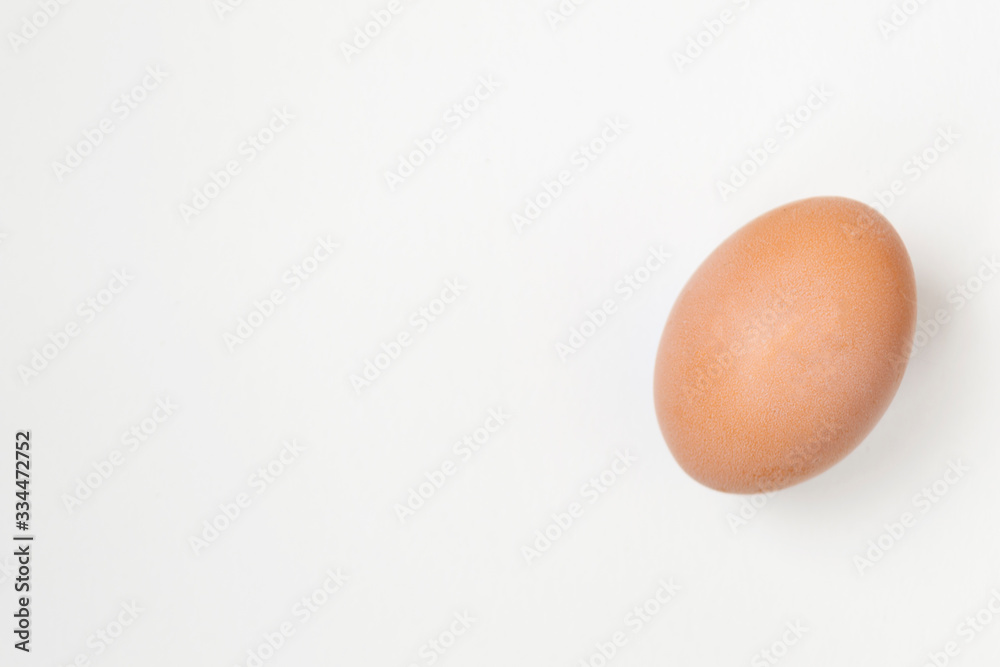 Close up of an egg lying on a white background. There is a place for text. Easter concep. Close up of an egg lying on a white background. There is a place for text. Easter concep.
