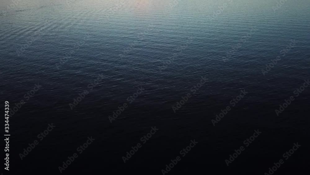 Tilt up on Calm Water during colourful sunset Tilt up on Calm Water during colourful sunset
