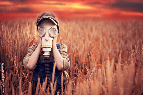 The child in the gas mask. Concept of environment pollution and natural disaster. Coronovirus epidemic.