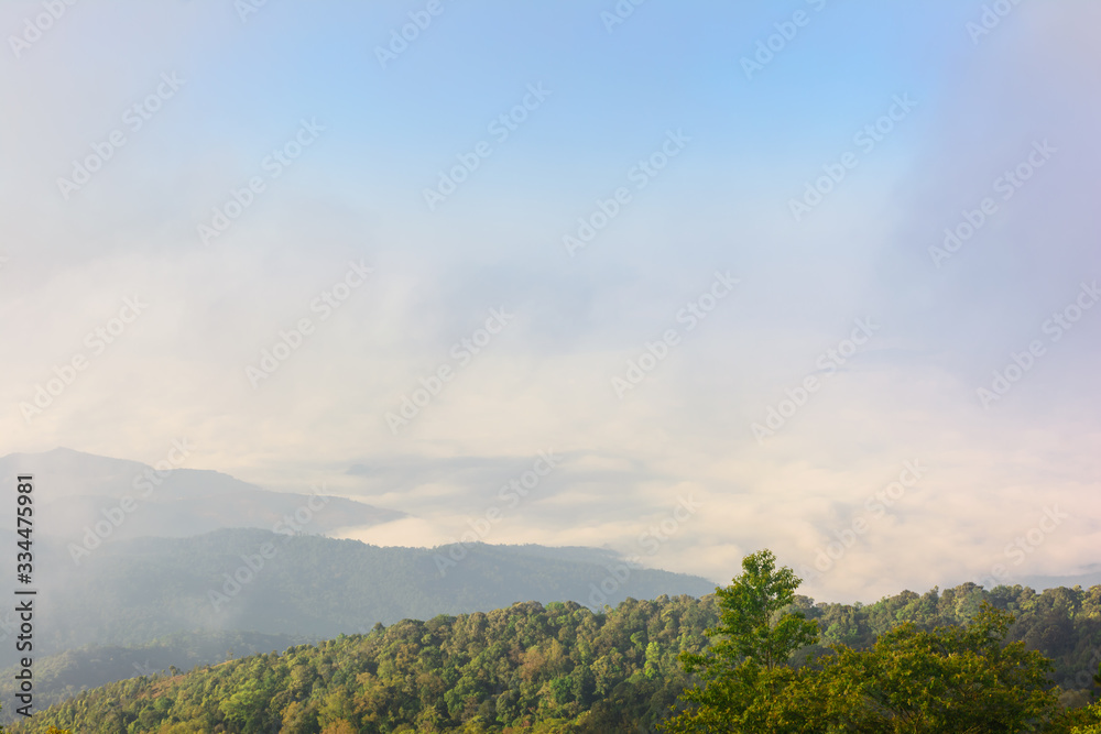 Obraz premium Nature landscape cloudy sky with mountain view and white fog in morning time at Thailand. Nature park and outdoor background