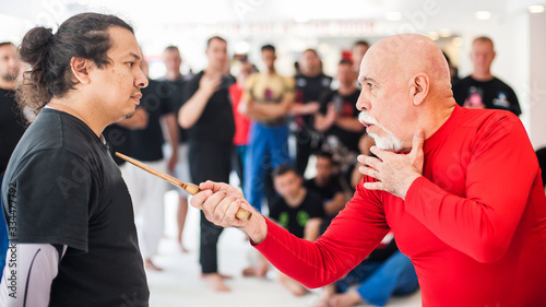 Kapap instructor shows knife techniques to large group of students photo