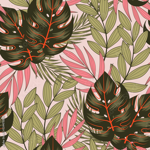 Original seamless tropical pattern with bright leaves and plants on a beige background. Exotic jungle wallpaper. Colorful stylish floral. Summer colorful hawaiian.