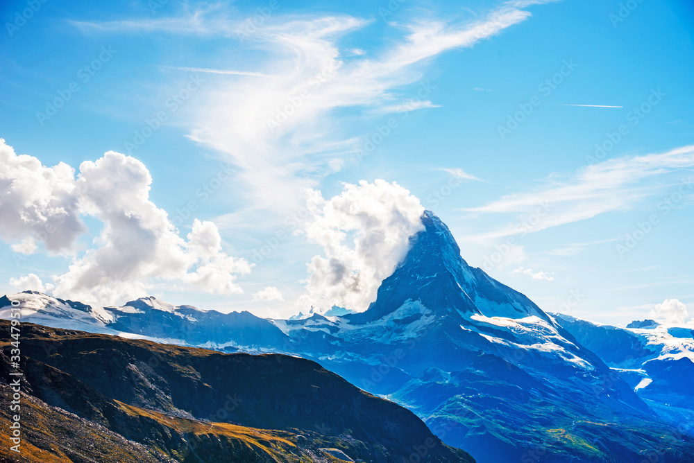 Fascinating landscape with with the top of the mountain Matterhorn in the clouds in the Swiss Alps, near Zermatt, Switzerland